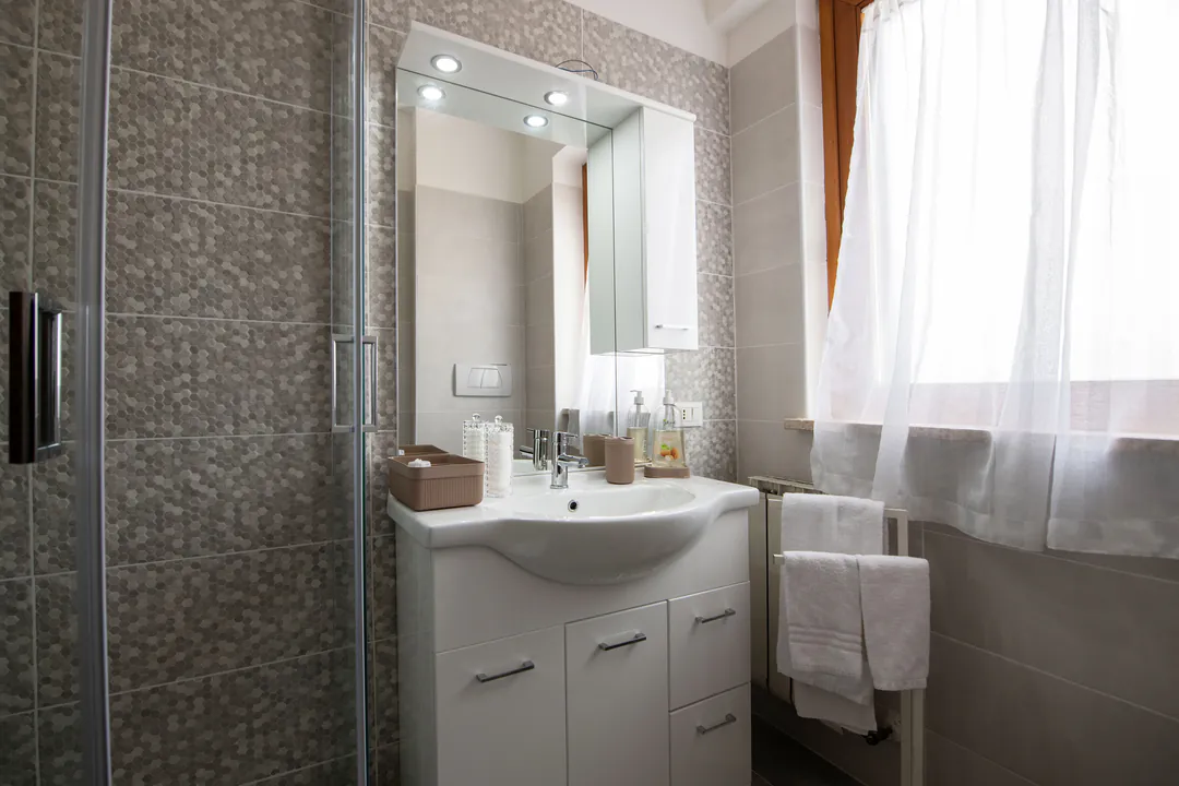 The bathroom with window and towels