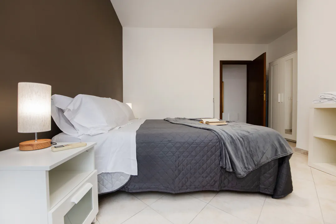 The bedroom with lamp and window